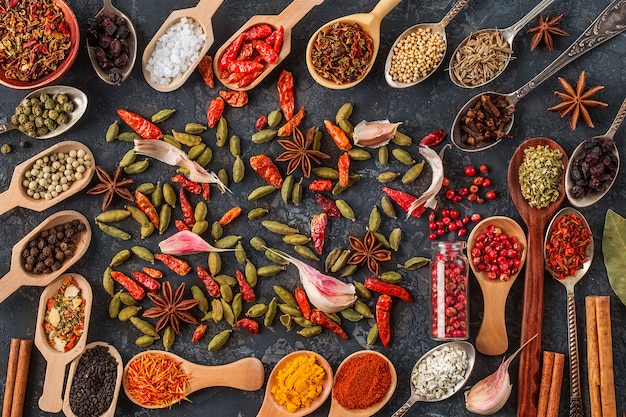 Spices and herbs for cooking in wooden spoons. 