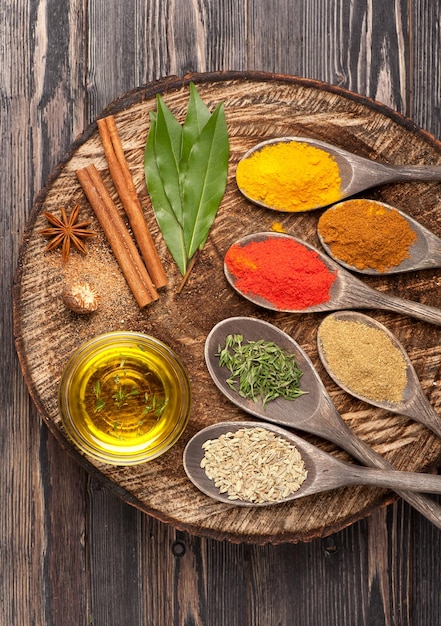 Spices and herbs on wooden board close up