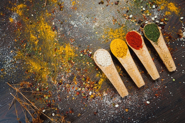 Spices and herbs in wooden spoons