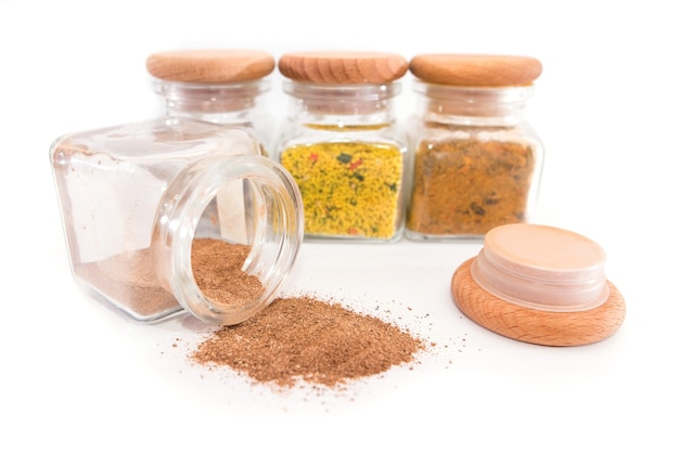 Spices in jars on a white surface