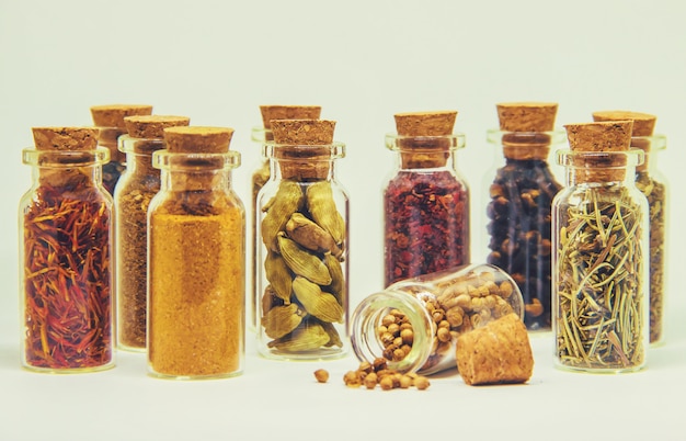 Spices in jars on wooden background. selective focus.