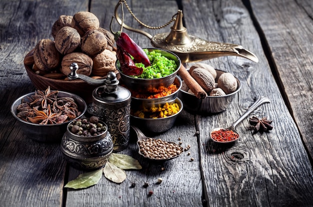 Spices and nuts at wooden table