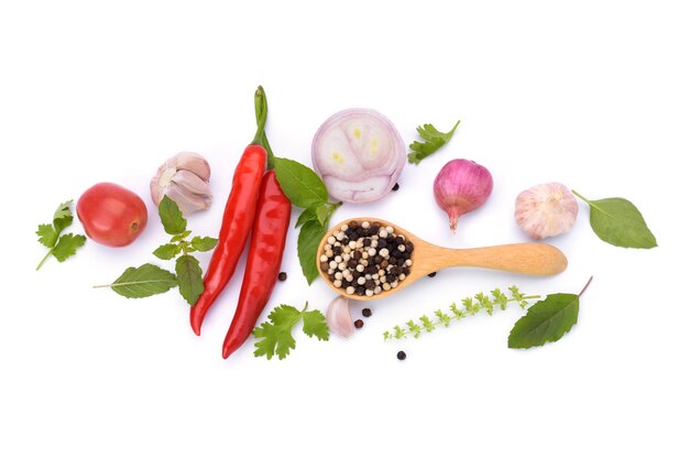 Spices red peppers and peppers laid out on a white background