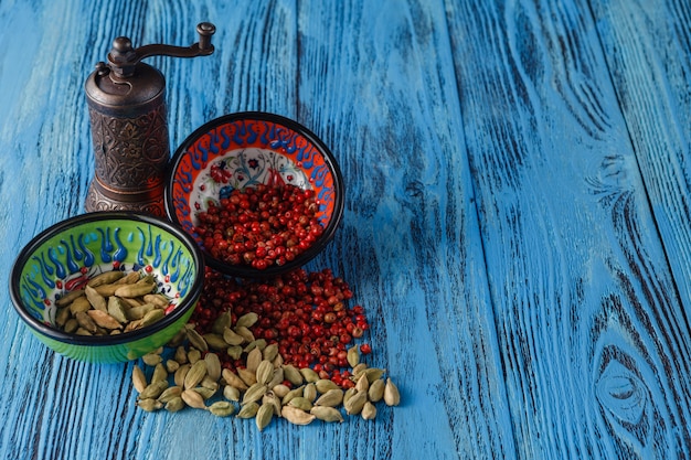 Spices scattered on a table and mill