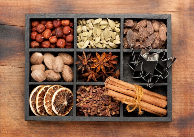 Spices seasonings spicy Christmas baking ingredients in a wooden box Top view
