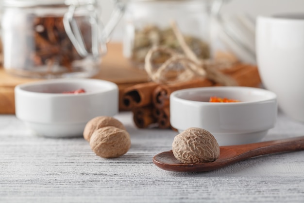 Spices in a small ceramic cups on a white background