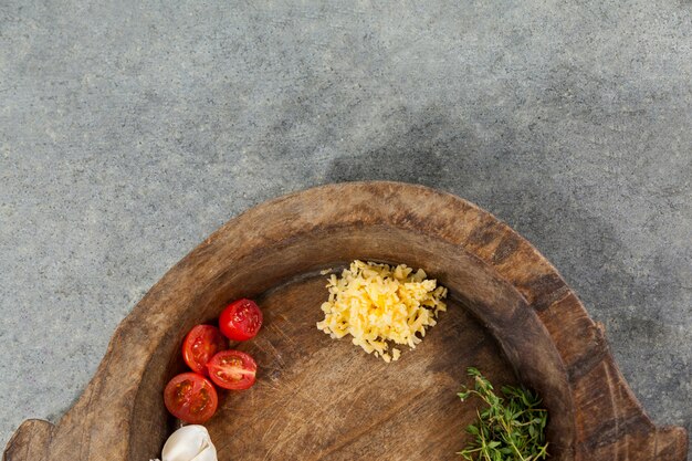 Spices and vegetable in wooden bowl