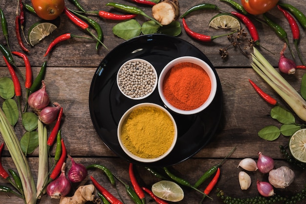 Spices with ingredients on wood background. asian food, healthy or cooking concept.