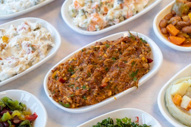 Spicy appetizer traditional turkish and arabic cuisine meze
snack meal served alongside the main course natural vegetarian food
local name yandim hacer bulk appetizer plates