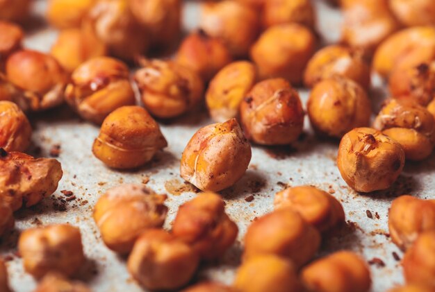 Spicy baked chickpeas scattered on baking paper