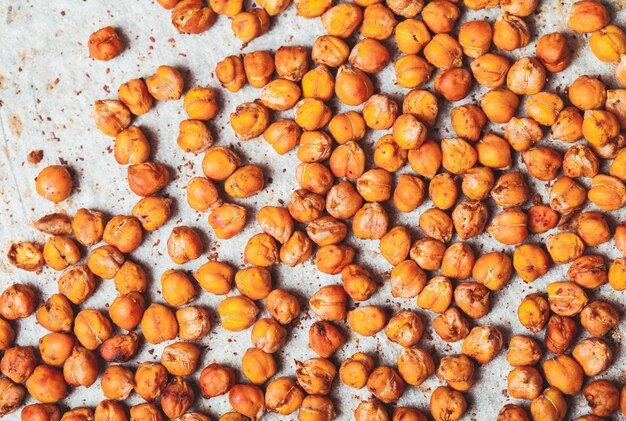 Spicy baked chickpeas scattered on baking paper