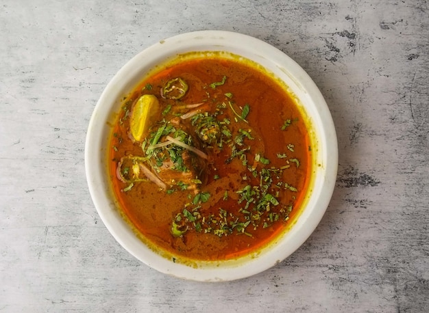 Spicy beef nihari served in a plate isolated on background top view of indian and pakistani desi food