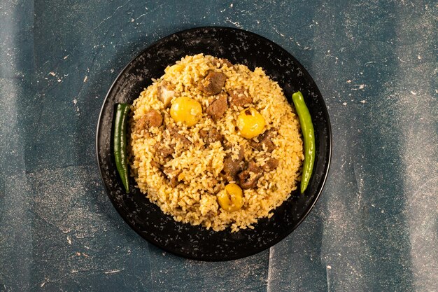 Spicy Beef Pulao in a dish isolated on marble background top view of beef biryani Pakistani and Indian food