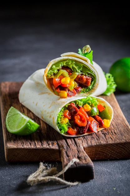 Spicy burrito with red salsa lettuce and vegetables
