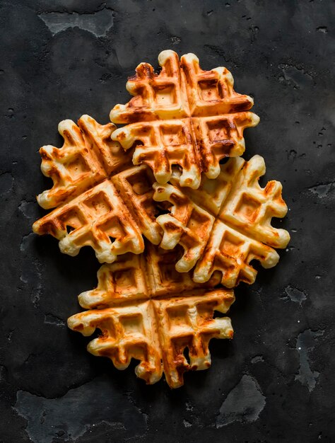 Spicy cheddar cheese waffles delicious breakfast snack on a dark background top view