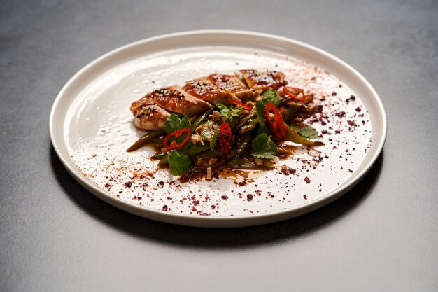 Spicy chicken breast with minted green beans, close-up