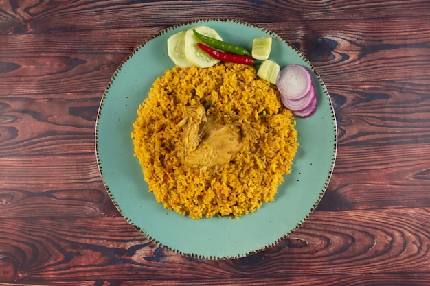 Пряный цыпленок pulao polao biryani mandi kacchi с салатом, подаваемым в блюде, изолированном на столе, вид на индийскую еду