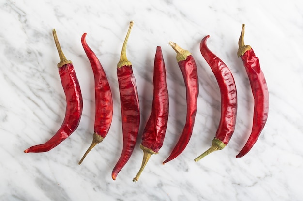 Spicy Chili peper on stone background, top view