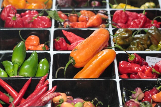 Spicy chili peppers of various colors sold at market