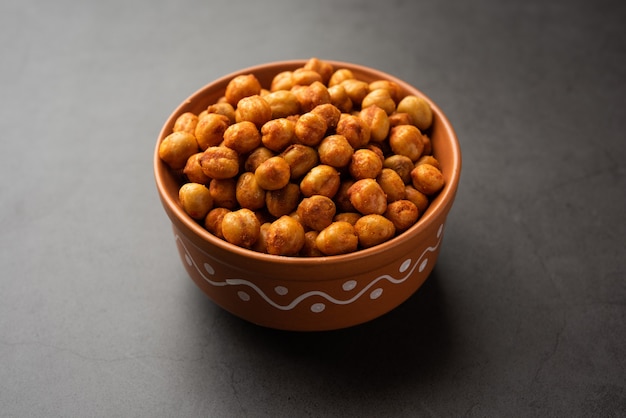 Spicy crispy roasted chickpeas with paprika, curry and hot chili pepper, selective focus