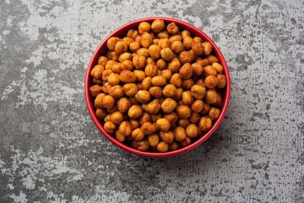 Spicy crispy roasted chickpeas with paprika, curry and hot chili pepper, selective focus