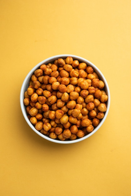 Spicy crispy roasted chickpeas with paprika, curry and hot chili pepper, selective focus