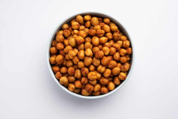 Spicy crispy roasted chickpeas with paprika, curry and hot chili pepper, selective focus