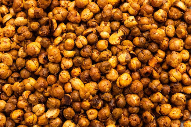 Spicy crispy roasted or fried chickpeas or futana with paprika, selective focus. Tasty popular vegetarian snack or side dish or chakna consumed with cocktail drinks