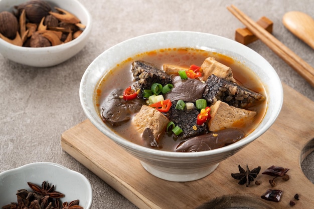 Spicy duck blood jelly soup and stinky tofu with scallion and chili pepper topping