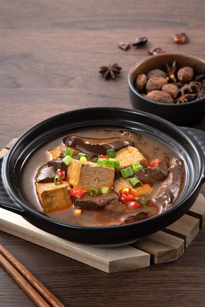 Spicy duck blood jelly soup and stinky tofu with scallion and chili pepper topping