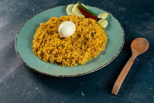 Spicy Egg pulao polao biryani mandi kacchi with egg and salad served in dish isolated on table top view of indian food