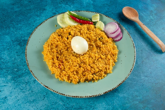 Spicy Egg pulao polao biryani mandi kacchi with egg and salad served in dish isolated on table top view of indian food