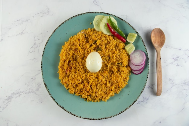 Spicy Egg pulao polao biryani mandi kacchi с яйцом и салатом подается в блюде, изолированном на столе, вид на индийскую еду