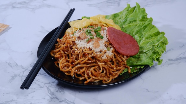 Spicy Fried Noodles topped with ground chicken and smoked beef