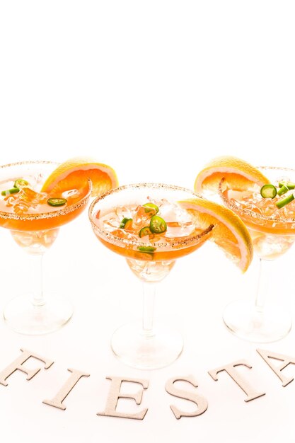 Spicy grapefruit margarita on ice in margarita glasses.