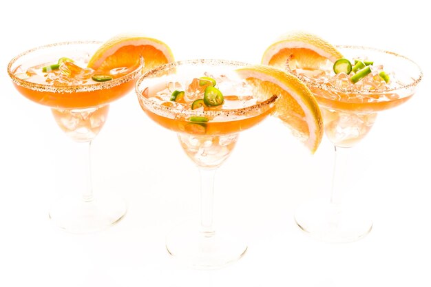 Spicy grapefruit margarita on ice in margarita glasses.