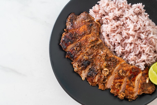 Spicy grilled Jamaican jerk chicken with rice - Jamaican food style