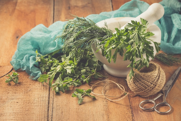 Spicy herb marjoram on a wooden table