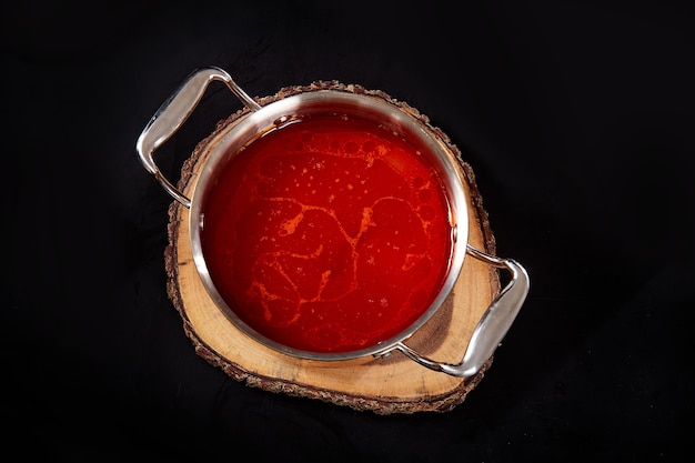 Spicy hot pot on black background