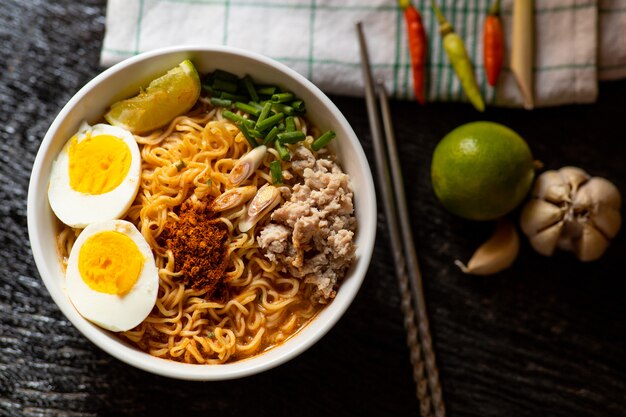 Spicy instant noodles soup with ingredient in bowl