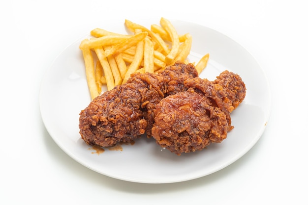 spicy Korean fried chicken with french fries isolated on white background