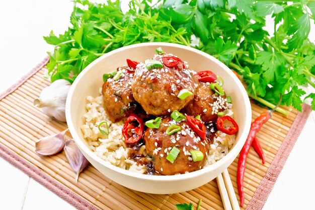 Spicy Korean meatballs in sauce of starch, soy sauce, vinegar and apricot jam, sprinkled with green onions