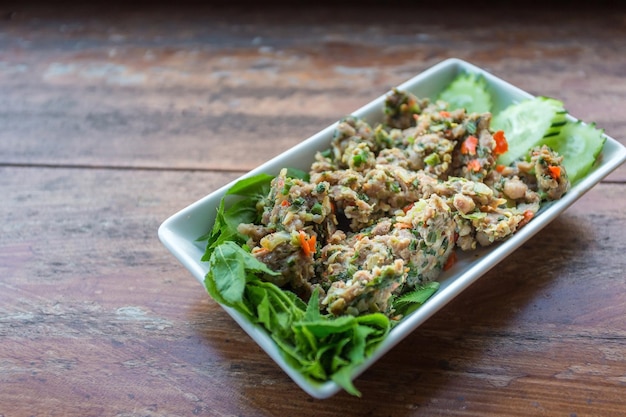 Spicy minced pork is contained with garlic chives long root which is one of traditional Akhas herb