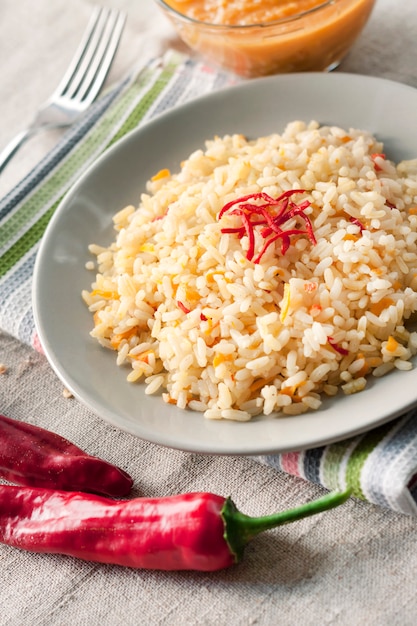 Spicy parboiled rice with carrots, yellow zucchini and chilli peppers