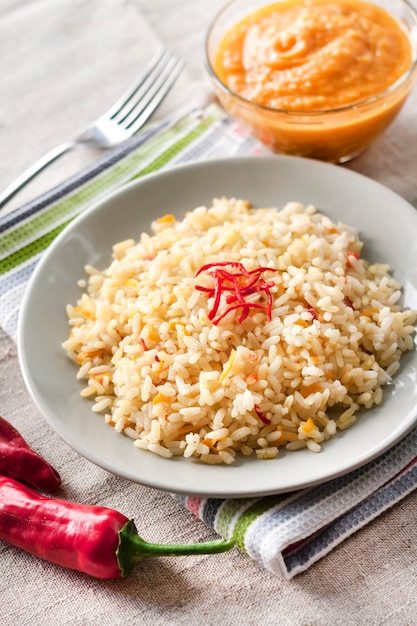 Spicy parboiled rice with carrots, yellow zucchini and chilli peppers