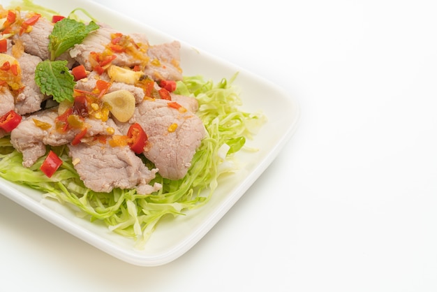 Spicy Pork Salad or Boiled Pork with Lime Garlic and Chili Sauce isolated on white