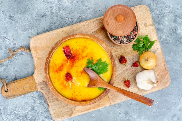 Spicy pumpkin puree soup with curry and saffron. Studio Photo.