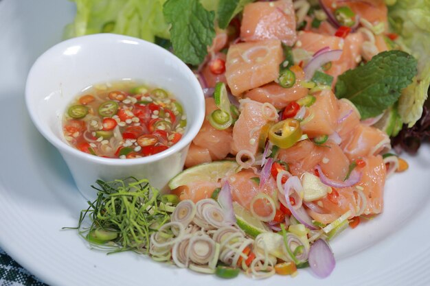 Spicy Salmon Salad with Thai Herbs in spicy  with spicy Thai salad ingredients and various herbs.