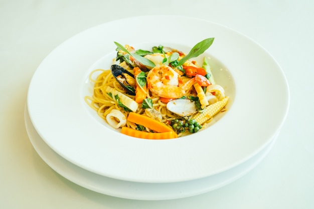 Spicy seafood spaghetti or pasta in white plate