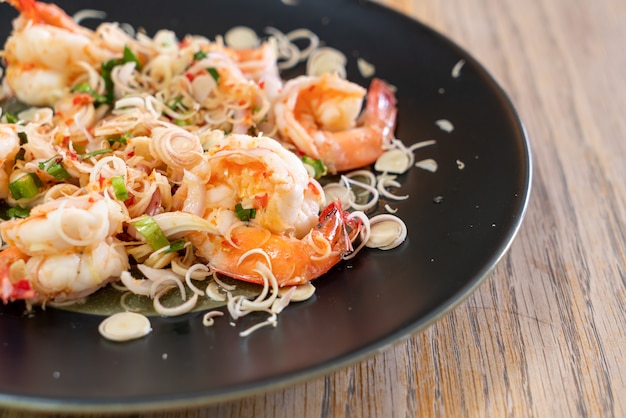 spicy shrimps salad with herb on plate